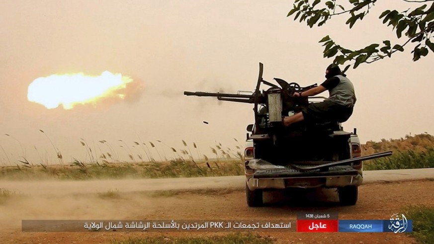 FILE -- This undated image posted online Monday, May 1, 2017, by supporters of the Islamic State militant group on an anonymous photo sharing website, purports to show an Islamic State fighter firing  ...