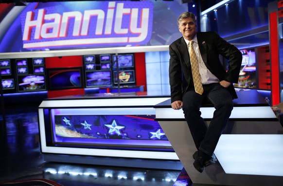 Fox News Channel anchor Sean Hannity poses for photographs as he sits on the set of his show &quot;Hannity&quot; at the Fox News Channel&#039;s studios in New York City, October 28, 2014. REUTERS/Mike ...