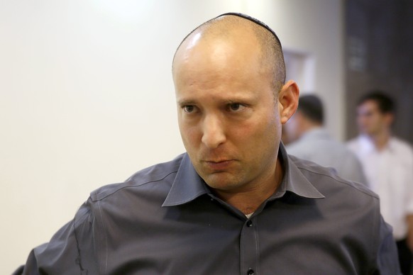 Israeli Economy Minister Naftali Bennett arrives to attend the weekly cabinet meeting in Jerusalem, Sunday, April 6, 2014. Speaking at a weekly Cabinet meeting Sunday, Israel’s Prime Minister Benjamin ...