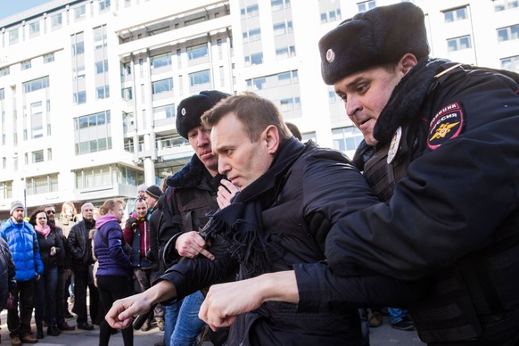 epa05871943 A handout photo made available by Navalny&#039;s Campaign Headquarters shows Russian opposition leader Alexei Navalny (C) being detained by Russian police officers during an opposition ral ...