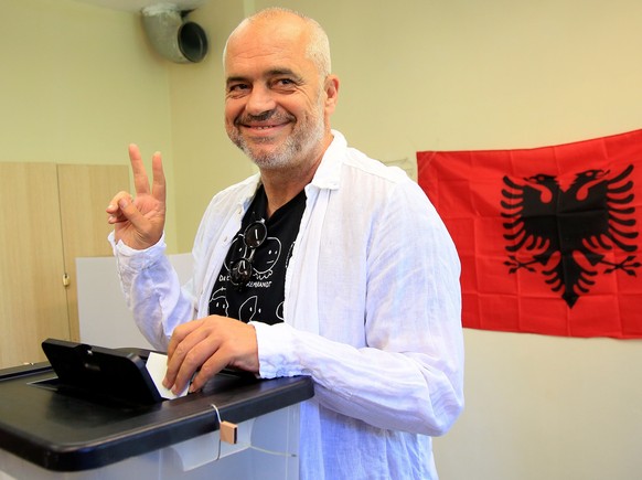 epa06049301 Albania&#039;s Prime Minister Edi Rama flashes a Victory gesture to the media as he casts his ballot at a polling station near Tirana, Albania, 25 June 2017. Albanians head to the polls on ...