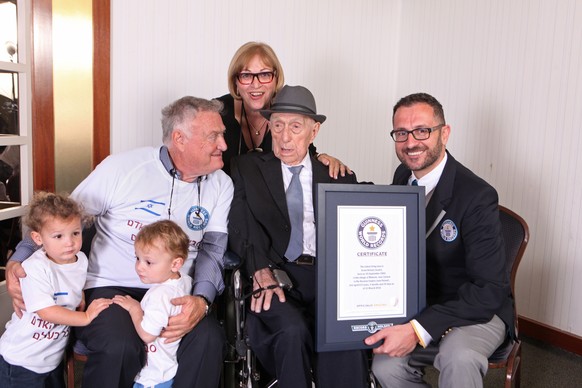 In this photo supplied by the Guinness World Records, Marco Frigatti, Head of Records for Guinness World Records, right, poses with Israel Kristal, second right, as he presents a certificate for being ...