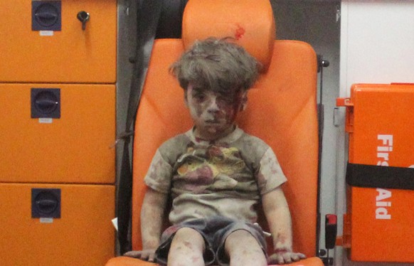 Five-year-old Omran Daqneesh, with bloodied face, sits inside an ambulance after he was rescued following an airstrike in the rebel-held al-Qaterji neighbourhood of Aleppo, Syria August 17, 2016. Pict ...