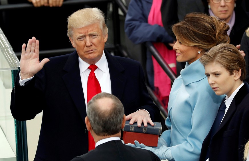 US President Donald Trump takes the oath of office with his wife Melania and son Barron at his side, during his inauguration at the U.S. Capitol in Washington, U.S., January 20, 2017. REUTERS/Kevin La ...