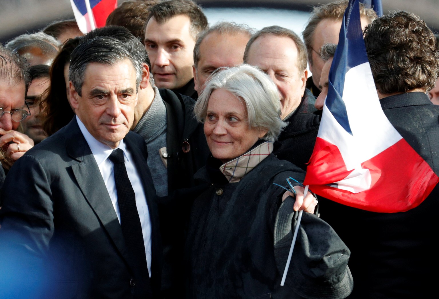 Francois Fillon, former French prime minister, member of The Republicans political party and 2017 presidential election candidate of the French centre-right and his wife Penelope (R) attend a meeting  ...