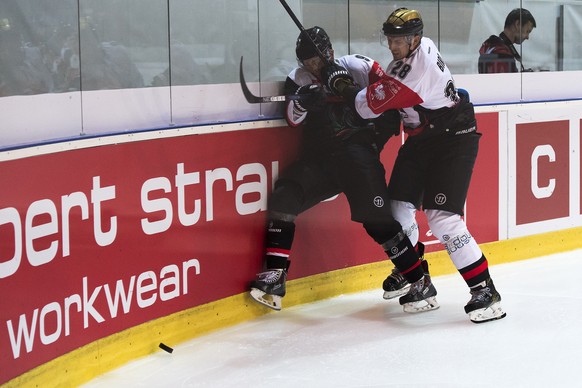 Player of HC Fribourg-Gotteron Caryl Neuenschwander, left, in action against player of HC Orli Znojmo Marek Biro, right, during the Champions Hockey League Group F hockey match between Switzerland&#03 ...