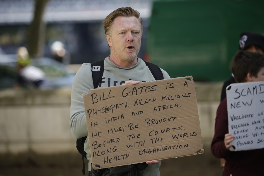 A man holds up an anti Bill Gates placard at a coronavirus anti-lockdown, anti-vaccine, anti-5G and pro-freedom protest near Scotland Yard, the headquarters of London&#039;s Metropolitan Police Servic ...