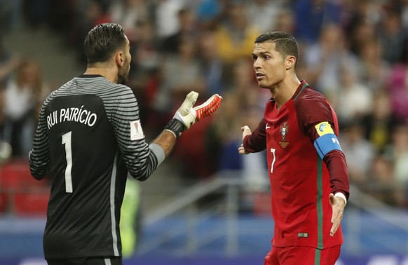 Portugal goalkeeper Rui Patricio talks to Portugal&#039;s Cristiano Ronaldo, right, during the Confederations Cup, semifinal soccer match between Portugal and Chile, at the Kazan Arena, Russia, Wednes ...