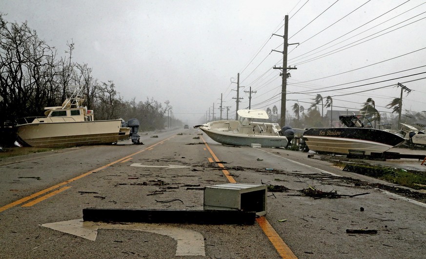 In this Sunday, Sept. 10, 2017, photo, boats block the Overseas Highway in the central part of the Florida Keys as Hurricane Irma passes. (Charles Trainor Jr/Miami Herald via AP)