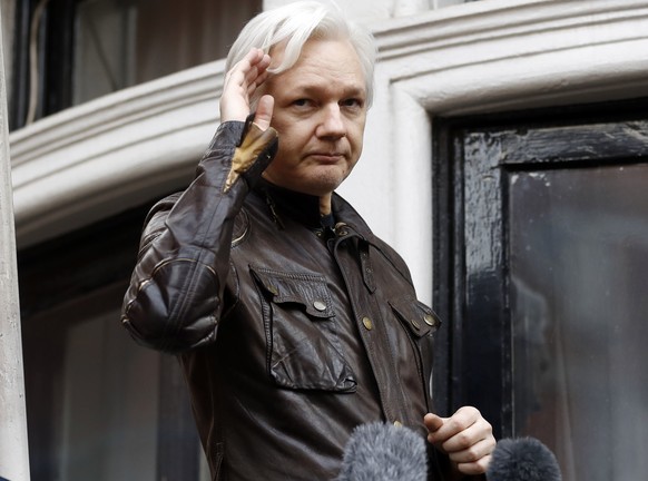 FILE - WikiLeaks founder Julian Assange greets supporters from a balcony of the Ecuadorian embassy in London, May 19, 2017. Britain