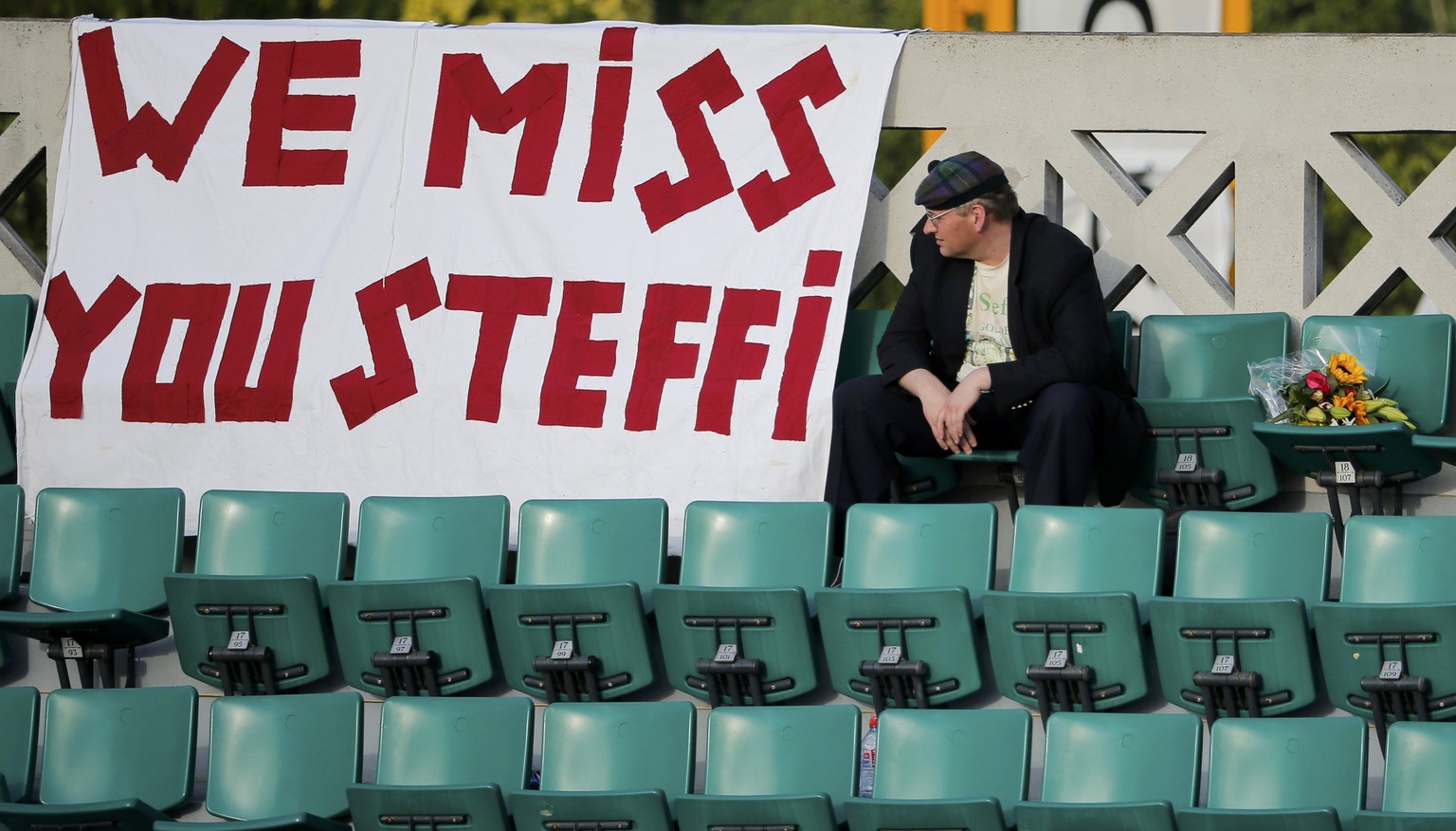 A man sits on the tribune next to a banner refeering to former German tennis player Steffi Graf during a match at the French Open Tennis tournament at the Roland Garros stadium in Paris June 7, 2014.  ...