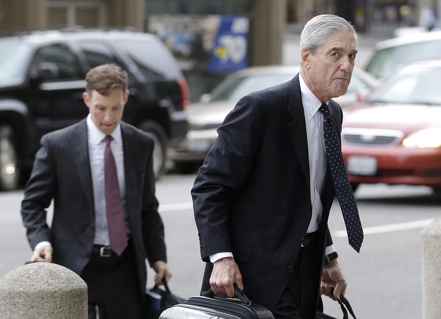 FILE - In this April 21, 2016 file photo, attorney and former FBI Director Robert Mueller, right, arrives for a court hearing at the Phillip Burton Federal Building in San Francisco. Mueller has been  ...