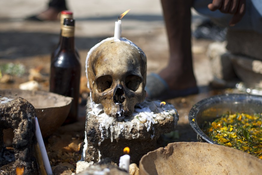 A human skull sits on a concrete block at the National cemetery during a Voodoo ritual that pays tribute to Baron Samdi and the Gede family of spirits during Day of the Dead celebrations in Port-au-Pr ...
