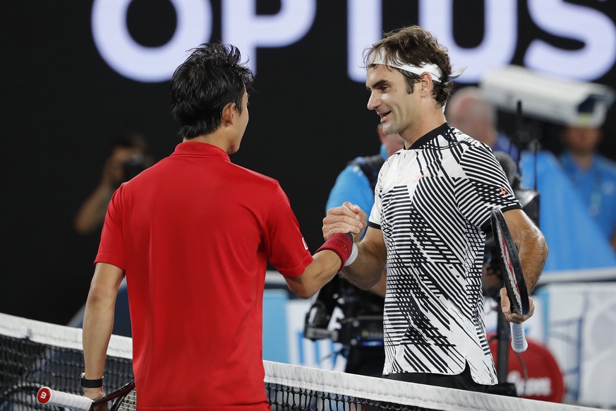 epa05741281 Roger Federer (R) of Switzerland shakes hand with Kei Nishikori of Japan after winning their Men&#039;s Singles fourth round match at the Australian Open Grand Slam tennis tournament in Me ...