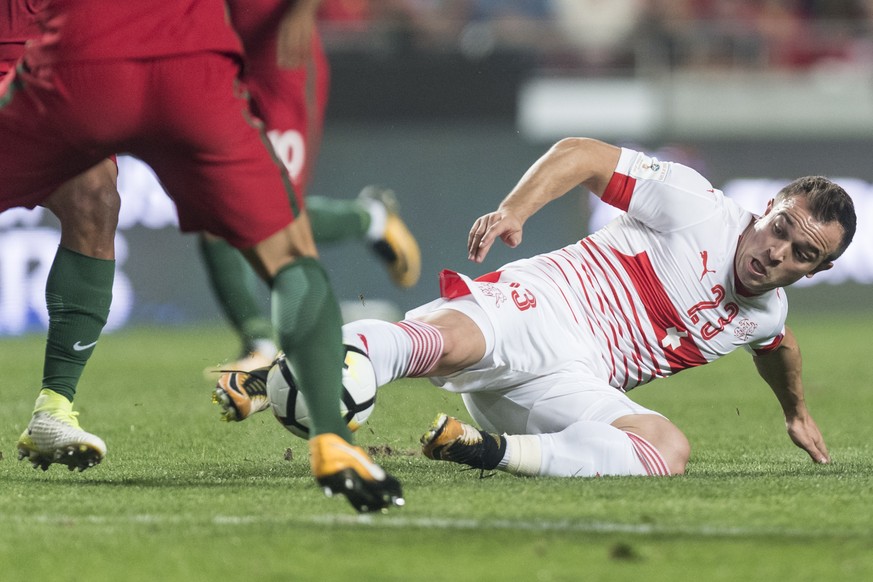 Switzerland&#039;s Xherdan Shaqiri, right, fights for the ball during the 2018 Fifa World Cup Russia group B qualification soccer match between Portugal and Switzerland at the Estadio da Luz stadium,  ...