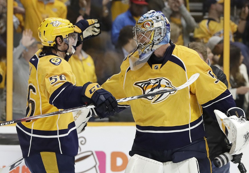 Nashville Predators left wing Kevin Fiala (56), of Switzerland, celebrates with goalie Pekka Rinne, right, of Finland, after Fiala scored the winning goal against the Chicago Blackhawks during overtim ...