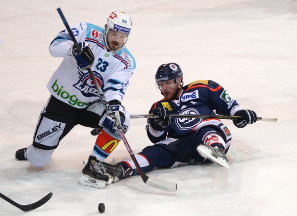 Ambri&#039;s player Adam Hall right, vies for the puck with Lakers&#039;s player Nikles Persson left, during the playout game of National League A (NLA) Swiss Championship 2014/15 between HC Ambri Pio ...