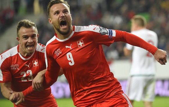 Switzerland&#039;s Haris Seferovic, right, celebrates with teammate Xherdan Shaqiri after scoring during the World Cup Group B qualifying soccer match between Hungary and Switzerland in Groupama Arena ...