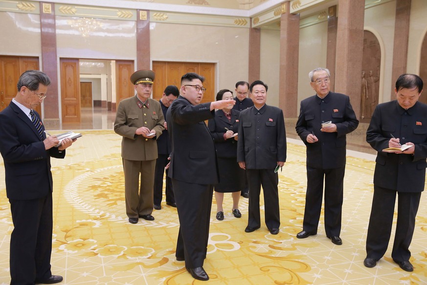 epa05875165 An undated photograph released by the North Korean Central News Agency (KCNA) on 28 March 2017 shows North Korean leader Kim Jong-un (C) giving field guidance to the remodelled Korean Revo ...