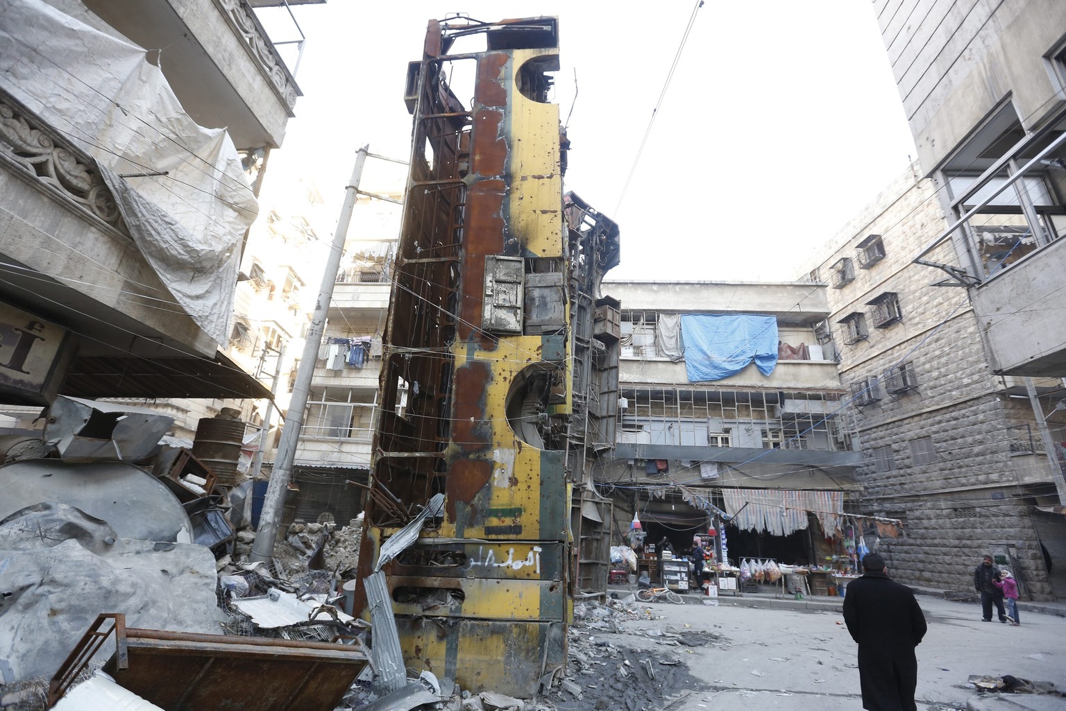 epa05767606 A side view of one of three damaged buses placed vertically and used as a barricade at a checkpoint during the conflicts, in the Bustan Alqasr neighborhood, one of the eastern neighborhood ...