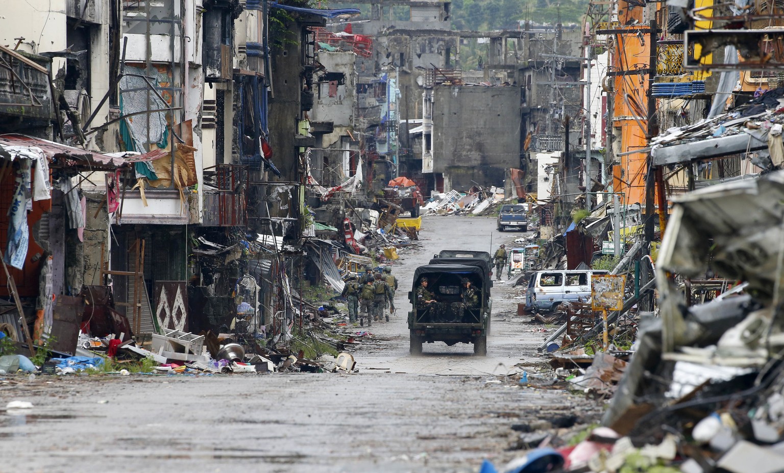 In thisTuesday, Oct. 17, 2017, file photo, Philippine troops return to their deployment after attending the ceremony where President Rodrigo Duterte declared the liberation of Marawi city in southern  ...