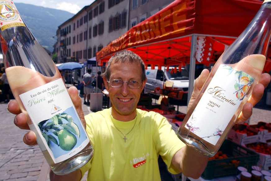 Regis Metrailler, producteur valaisan de Barr-Nendaz, presente ses eau-de-vies, lors du Marche au Grand Pont a Sion, ce vendredi 11 juillet 2003. (KEYSTONE/Olivier Maire)