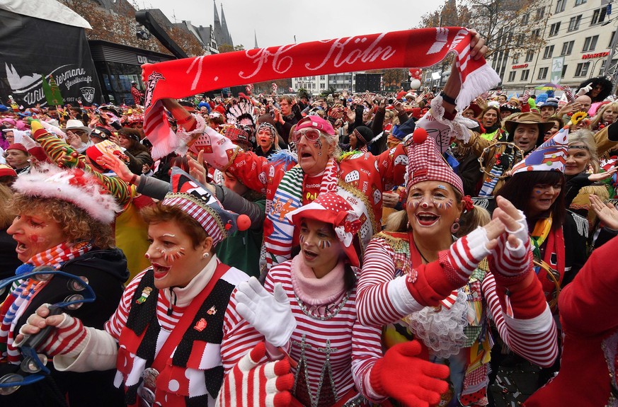 Revelers celebrate the start of the carnival season in the streets of Cologne, Germany, on Friday, Nov. 11, 2016. (AP Photo/Martin Meissner)