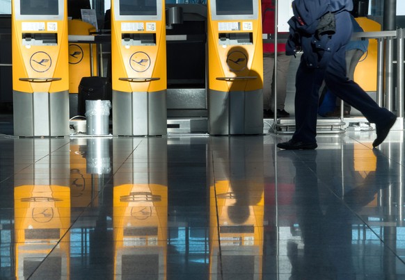 epa05651891 Lufthansa self-service counters reflected in the floor of the departures hall at the airport in Munich, Germany, 29 November 2016. Hundreds of flights have been cancelled. Lufthansa inform ...