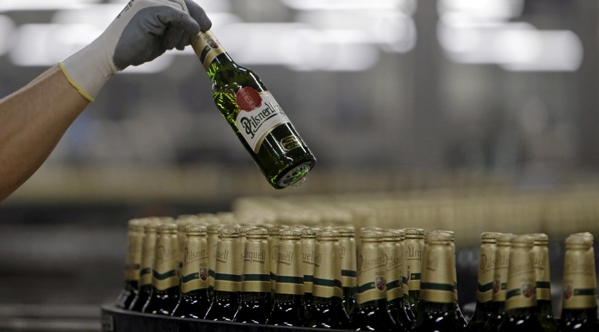 A worker checks bottles of beer at Plzensky Prazdroj (Pilsner Urquell) brewery in Plzen, Czech Republic, November 12, 2015. REUTERS/David W Cerny/File Photo