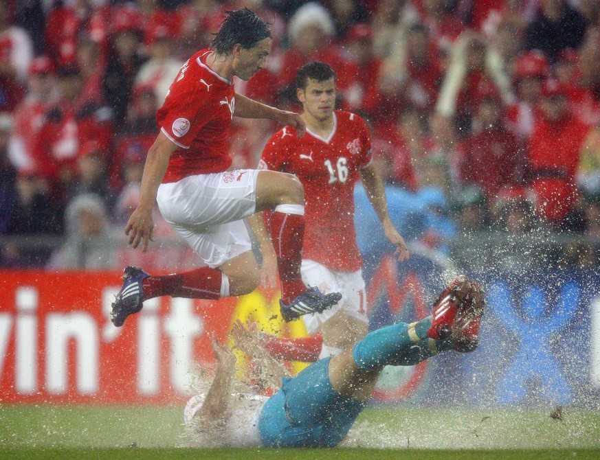 Switzerland&#039;s Hakan Yakin, left, and his teammate Tranquillo Barnetta, back, fight against Turkey&#039;s Hakan Balta, down, during the second match of Group A between Switzerland and the Republic ...