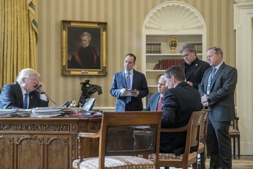 President Donald Trump, accompanied by from second from left, Chief of Staff Reince Priebus, Vice President Mike Pence, National Security Adviser Michael Flynn, Senior Advisor Steve Bannon, and White  ...