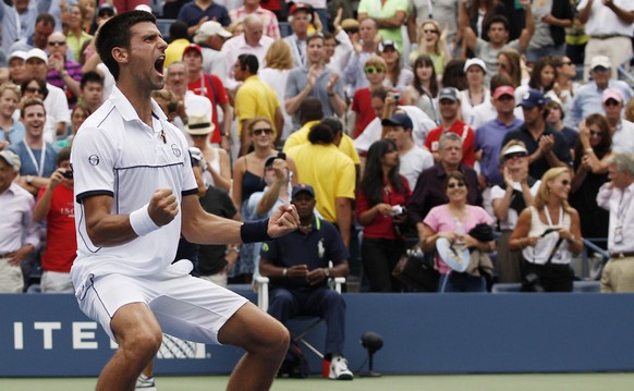 Novak Djokovic of Serbia reacts after winning a semifinal match against Roger Federer of Switzerland at the U.S. Open tennis tournament in New York, Saturday, Sept. 10, 2011. (AP Photo/Charles Krupa)