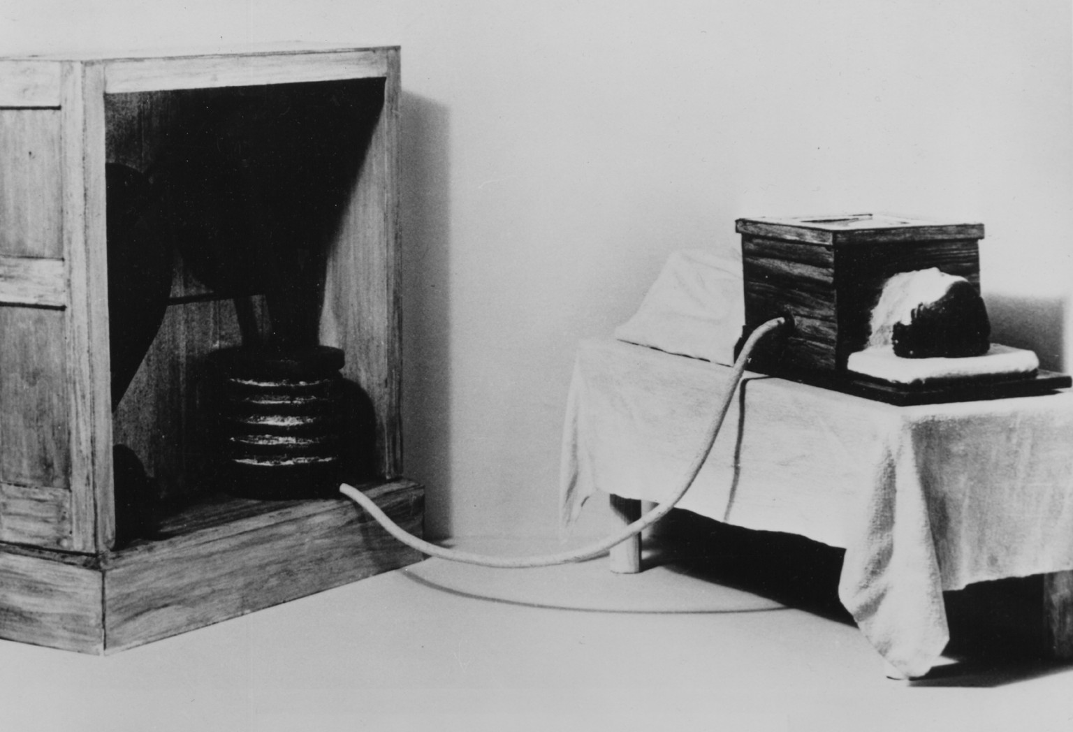 An image of a model of a resuscitation technique used in 1918 AD, the Stewart Method which has the following caption, First air tight cabinet method, Chamber connected to bellows which created positiv ...