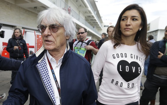 FILE - In this Nov. 14, 2013 file photo, President and CEO of Formula One Management Bernie Ecclestone, center, arrives with his wife Fabiana Flosi at the Circuit of the Americas for the Formula One U ...