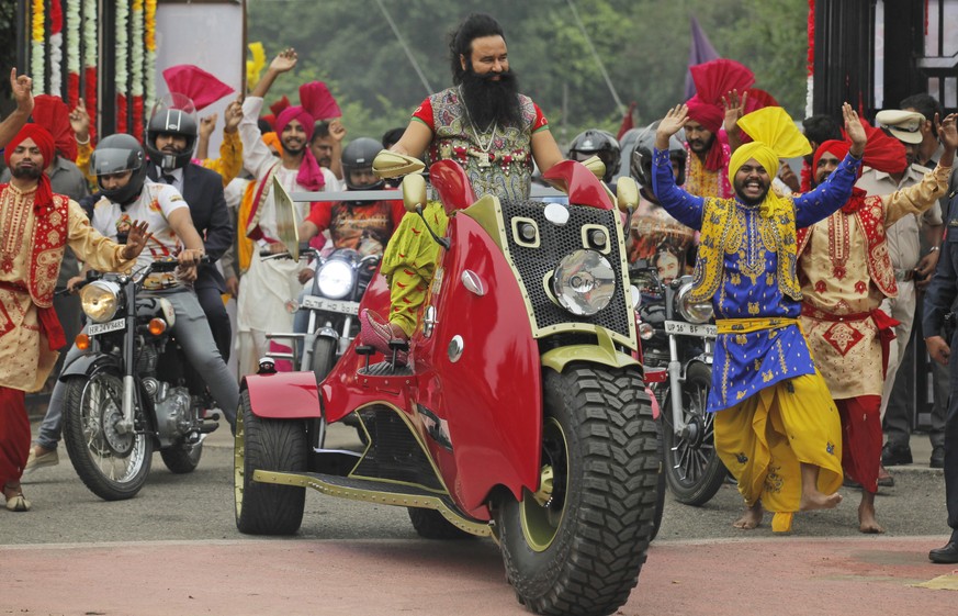 In this Wednesday, Oct. 5, 2016 photo, Indian spiritual guru, who calls himself Saint Dr. Gurmeet Ram Rahim Singh Ji Insan, arrives for a press conference ahead of the release of his new film &quot;MS ...