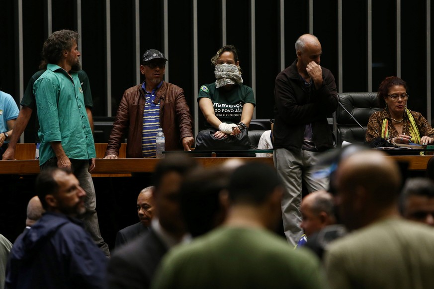 Demonstrators in favor of a military intervention in Brazil invade the lower house plenary session in Brasilia, Brazil, November 16, 2016. REUTERS/Adriano Machado