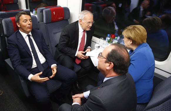epa05340233 (L-R) Italian Prime Minister Matteo Renzi, Swiss Federal President Johann Schneider-Ammann, French President Francois Hollande and German Chancellor Angela Merkel sit in the VIP-train driv ...