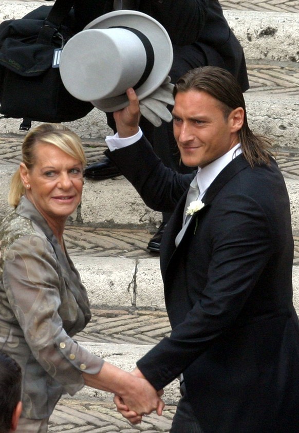 Roma&#039;s captain Francesco Totti holding the hand of his mother Fiorella arrives at the Roman church of Santa Maria in Ara Coeli for his wedding with celebrity girlfriend Ilary Blasi, Sunday, June  ...