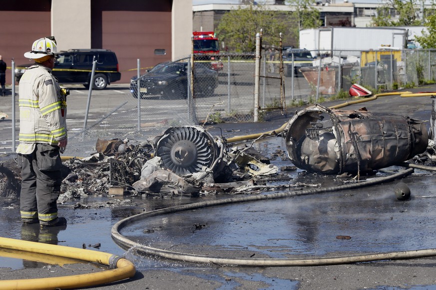 A firefighter stands looks over the scene after a jet crashed into a building near Teterboro Airport in Carlstadt, N.J., Monday, May 15, 2017. (Aristide Economopoulos/NJ Advance Media via AP)