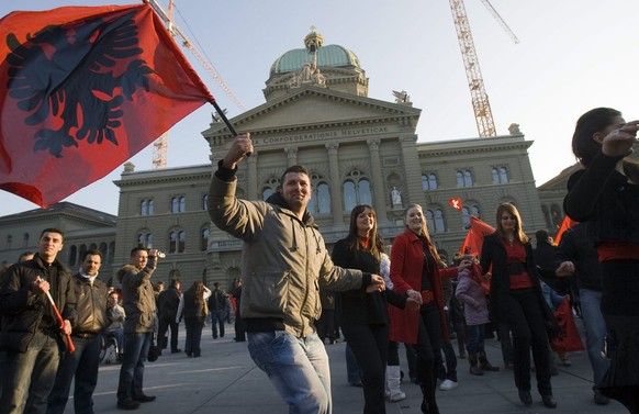 Around a thousand Kosovo Albanian emigrants fly Albanian flags to celebrate the declaration of independence of their province from Serbia on the Federal Palace in Bern, Switzerland, Sunday, February 1 ...