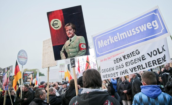 Fremdenfeindliche Demonstranten zeigen Merkel in Nazi-Uniform