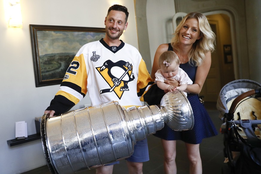 Switzerland&#039;s Mark Streit, his wife Fabienne and daughter Victoria, pose with the Stanley Cup trophy in Bern, Switzerland, August 2, 2017. Streit won the trophy with the Pittsburgh Penguins in 20 ...