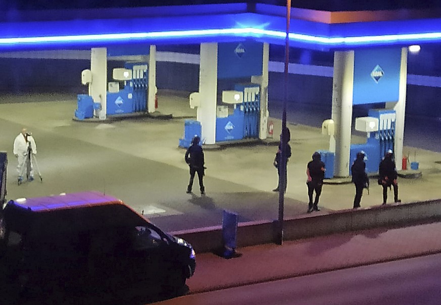 Police officers secure a gas station in Idar-Oberstein, Germany, Sunday, Sept. 19. Police in Germany say a 49-year-old man has been arrested on suspicion of murder in connection with the killing of th ...