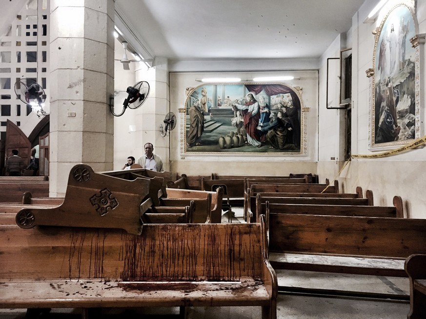 FILE -- In this Sunday, April 9, 2017 file photo, blood stains pews inside the St. George Church after a suicide bombing, in Tanta, Egypt. The Palm Sunday deadly bombings of two churches left Egyptian ...