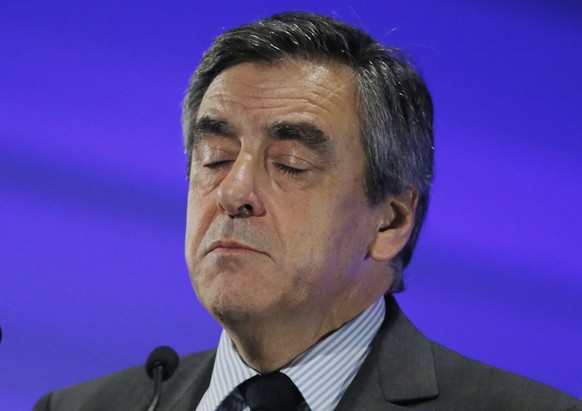 Conservative presidential candidate Francois Fillon pauses as he speaks during a meeting in Courbevoie, outside Paris, France, Tuesday, March 21, 2017. The first French presidential ballot will take p ...