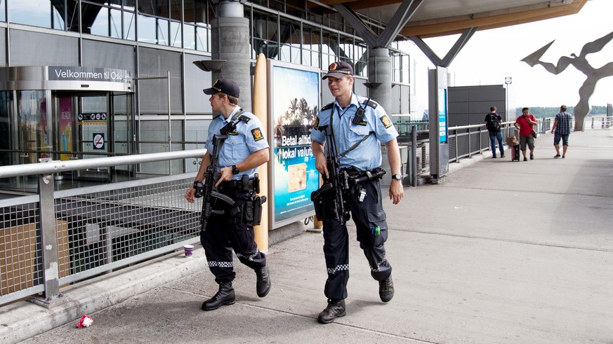Armed Police patrol outside the terminal building at Oslo Airport, Thursday, July 24, 2014. Norway&#039;s intelligence service says it has been warned of an imminent &quot;concrete threat&quot; agains ...