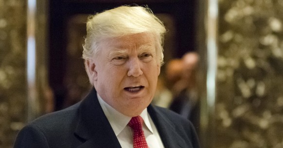 epa05662446 US President-elect Donald Trump maks an appearance in the lobby of Trump Tower to address reporters in New York, NY, USA, 06 December 2016. EPA/ALBIN LOHR-JONES / POOL