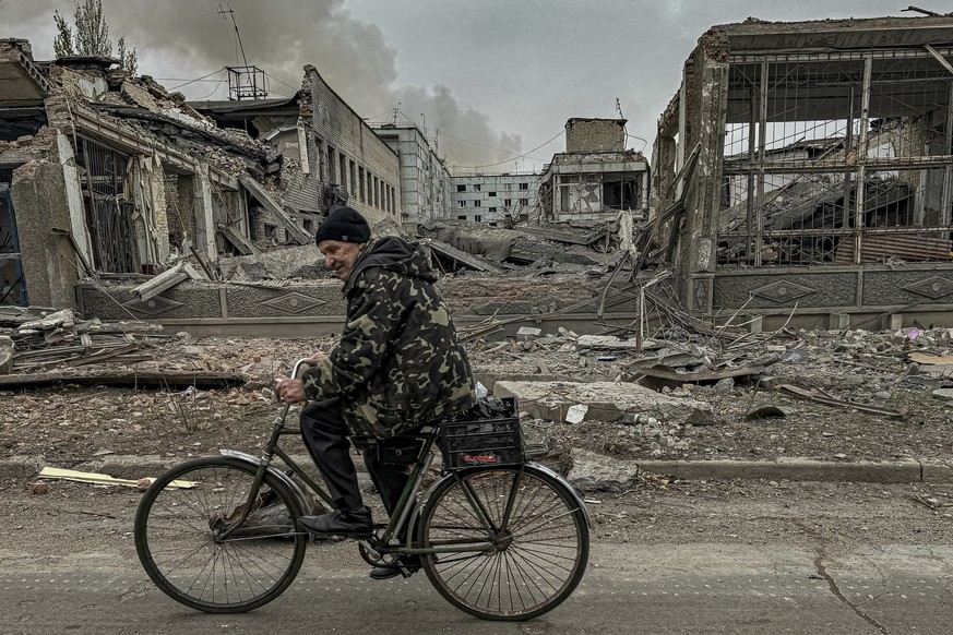 Nachrichten Linkding A man rides on a bike in front of the mail office which was destroyed by a Russian airstrike in Kurakhove, Donetsk region, Ukraine, on Nov. 7, 2024. (AP Photo/Anton Shtuka)