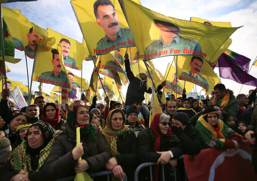 epa05628232 Kurds and Alevi hold flags featuring PKK leader Abdullah Ocalan protest against the Turkish President Recep Tayyip Erdogan, in Cologne, Germany, 12 November 2016. Around 10,000 Alevi and K ...