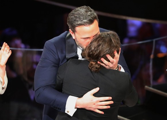 89th Academy Awards - Oscars Awards Show - Hollywood, California, U.S. - 26/02/17 - Casey Affleck (R) hugs his brother Ben after winning the Best Actor Oscar. REUTERS/Lucy Nicholson
